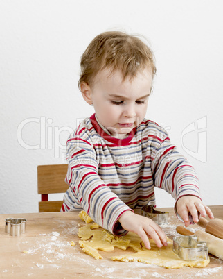 child at desk making cookies