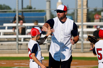 Little league baseball boy with coach