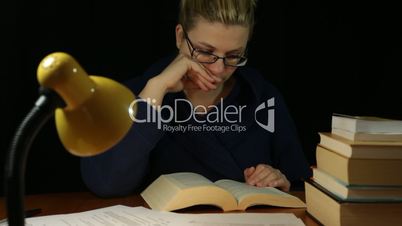 Happy woman reading book at night