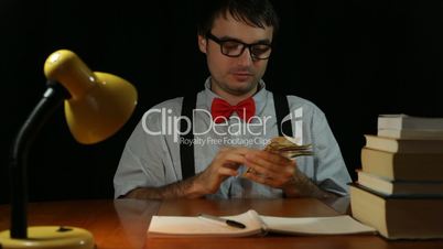Funny ecstatic rich nerd man with money
