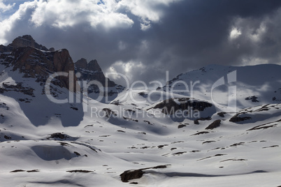 snowy mountains in storm clouds