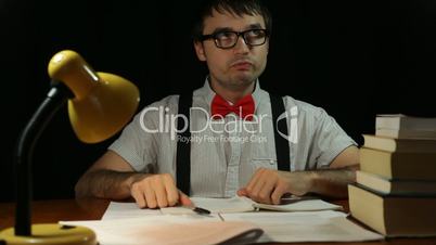 Funny nerd man working overtime at night