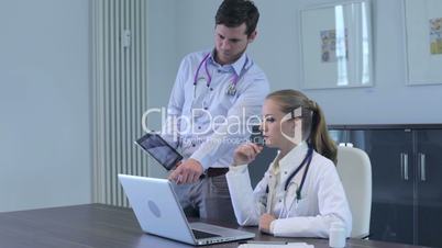 Two young doctors having a discussion