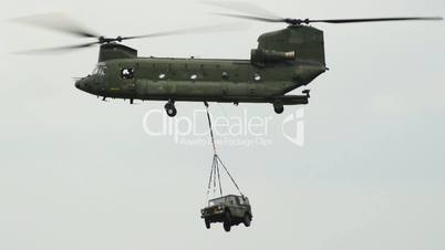 Chinook CH-47 helicopter carries a jeep on the hook 10973