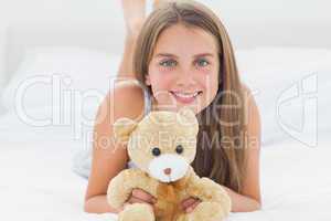 Cute young girl holding a teddy bear