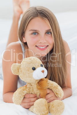 Young girl holding a teddy bear