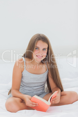 Cheerful girl reading a book
