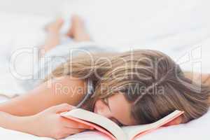 Young girl sleeping while holding a book