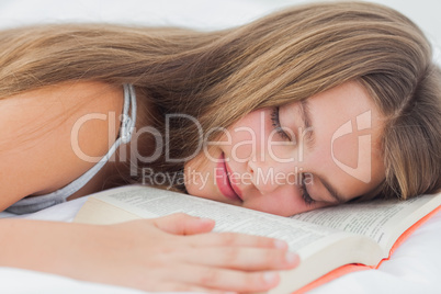 Cute girl sleeping while holding a book