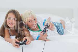 Cheerful siblings playing video games