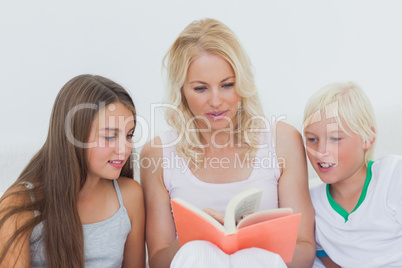 Mother reading a story to her children