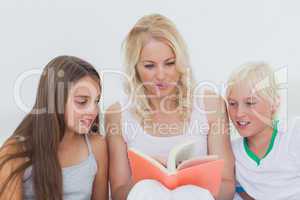 Mother reading a story to her children