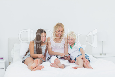 Mother and children reading a magazine