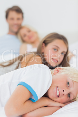 Children resting in the bed of their parents