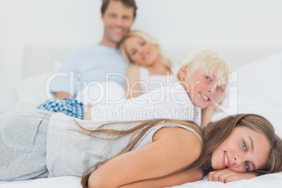 Siblings lying on the bed