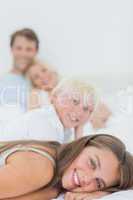 Smiling siblings lying on the bed