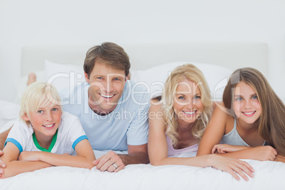 Parents and children lying on the bed