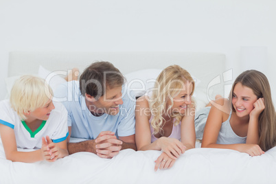 Family lying on the bed