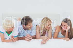 Family lying on the bed