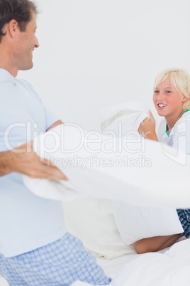 Pillow fight between and father and his son