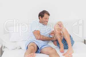 Father tickling son