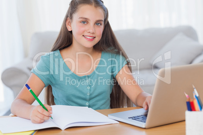 Smiling girl doing her homework
