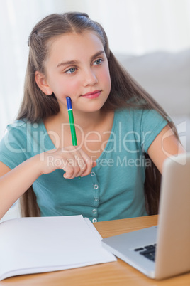 Thinking girl doing her homework