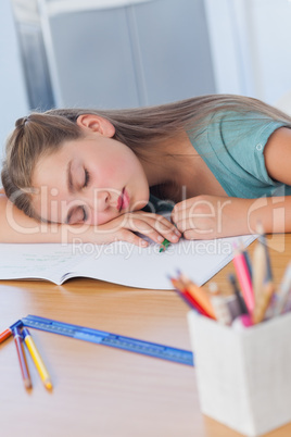 Little girl sleeping on books