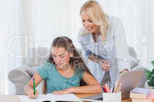 Mother helping her daughter during her homework