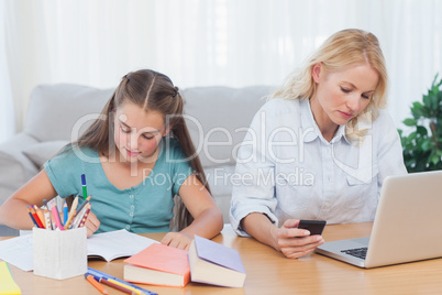 Woman using laptop at desk in living room
