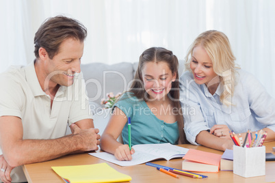 Parents helping her daughter doing her homework