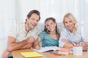 Parents helping her daughter to do her homework