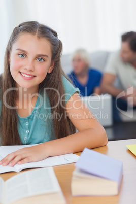 Cheerful girl doing her homework