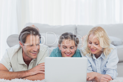 Parents and daughter using a laptop