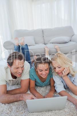 Daughter and parents using a laptop