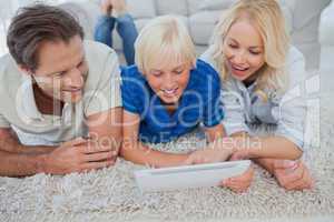 Son and parents using a tablet