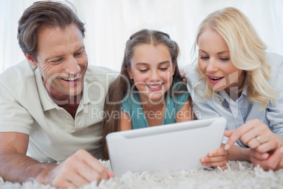 Girl and her parents using a tablet