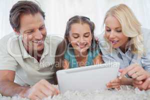 Girl and her parents using a tablet