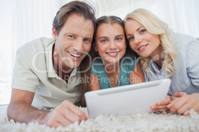 Portrait of a girl and her parents using a tablet