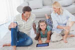 Young girl and her parents using a tablet