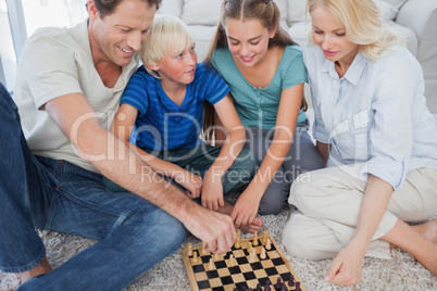 Portrait of a cheerful family playing chess