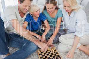 Portrait of a cheerful family playing chess