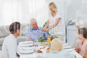 Woman serving salad at the dinner table