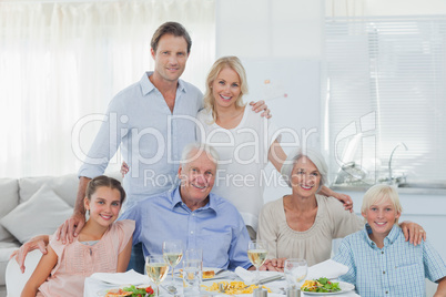 Extended family smiling at the dinner table