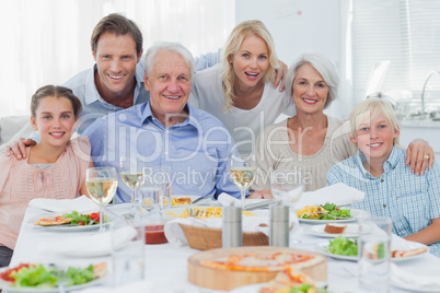 Extended family smiling at dinner family