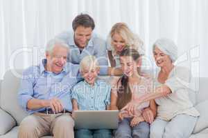 Extended family sitting on sofa