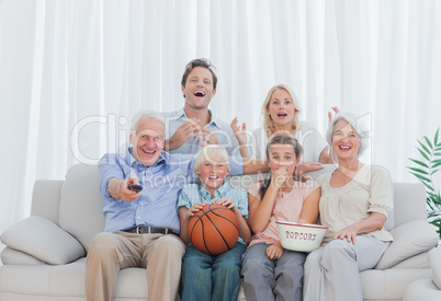 Extended family watching the television