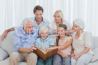 Extended family looking at a photo album