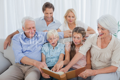 Extended family looking at their album photo