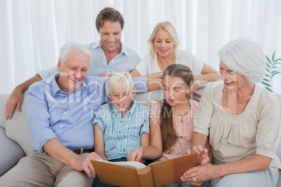 Extended family looking at an album photo